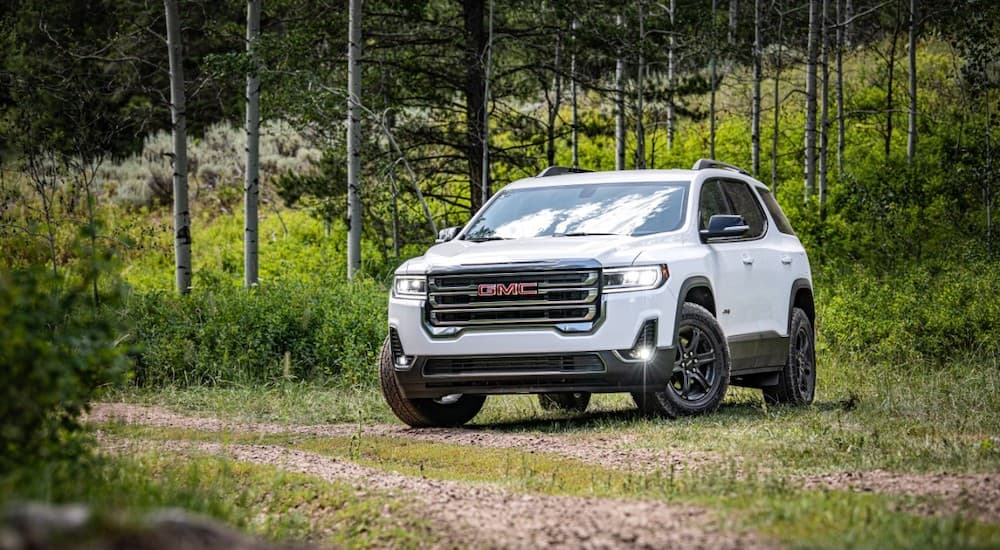 A white 2020 GMC Acadia AT4 is shown from the front at an angle.