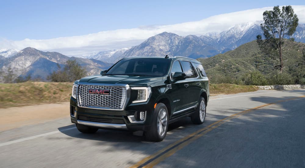 A black 2022 GMC Yukon Denali is shown from the front at an angle.
