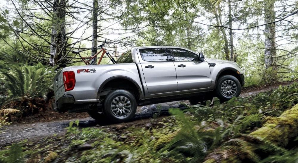 A silver 2023 Ford Ranger XLT FX4 is shown off-roading.