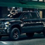 A black 2023 Chevy Silverado 1500 Midnight Edition is shown from the side after winning a 2023 Chevy Silverado 1500 vs 2023 Ram 1500 comparison.