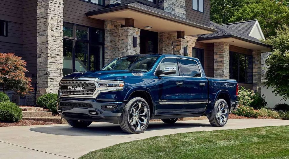 A blue 2023 Ram 1500 is shown parked on a driveway.