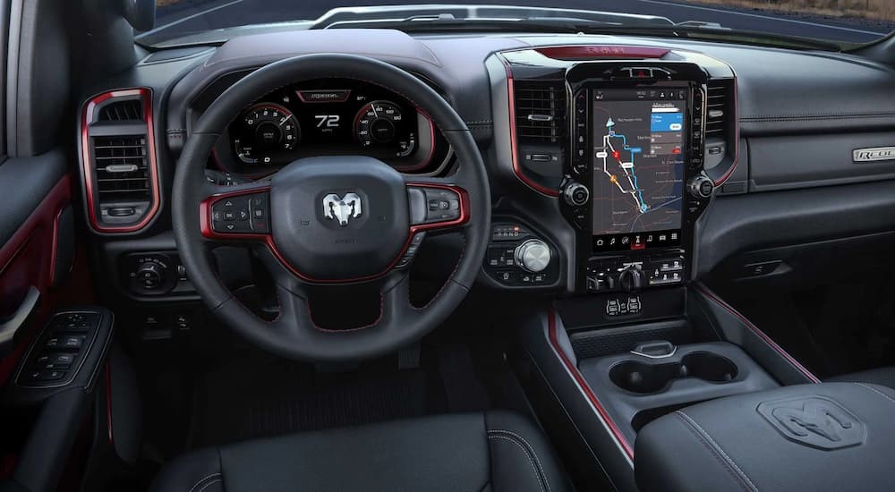 The red and black interior and dash of a 2023 Dodge Ram 1500 is shown.
