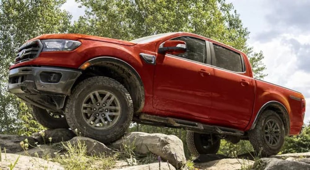 A red 2023 Ford Ranger is shown off-roading after having left a Ford truck dealer.