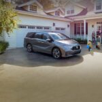A 2023 Honda Odyssey is shown parked in a driveway.