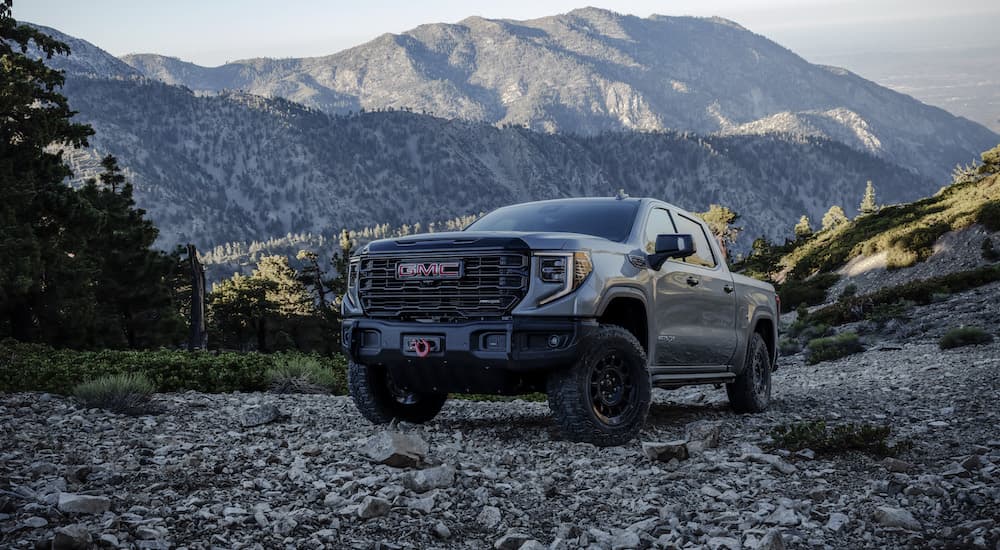 A grey 2023 GMC Sierra AT4x AEV is shown from the front at an angle.