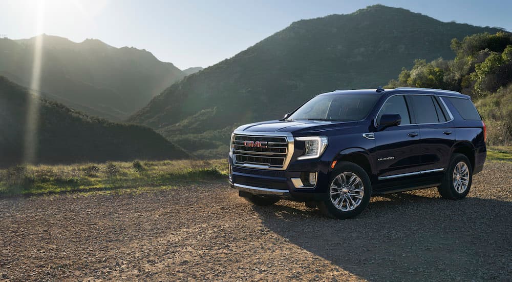 A black 2023 GMC Yukon SLT is shown from the front at an angle.