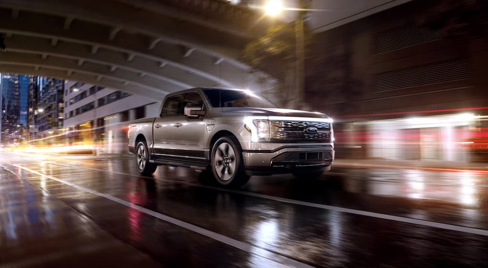 A silver 2023 Ford F-150 Lightning is shown from the front at an angle after leaving a Ford Lightning dealer.