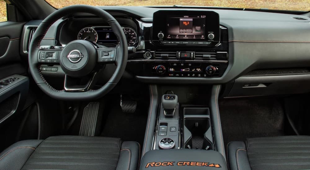 The black interior of a 2023 Nissan Pathfinder Rock Creek is shown from above the center console.