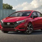 A red 2023 Nissan Versa SR is shown parked on a driveway.