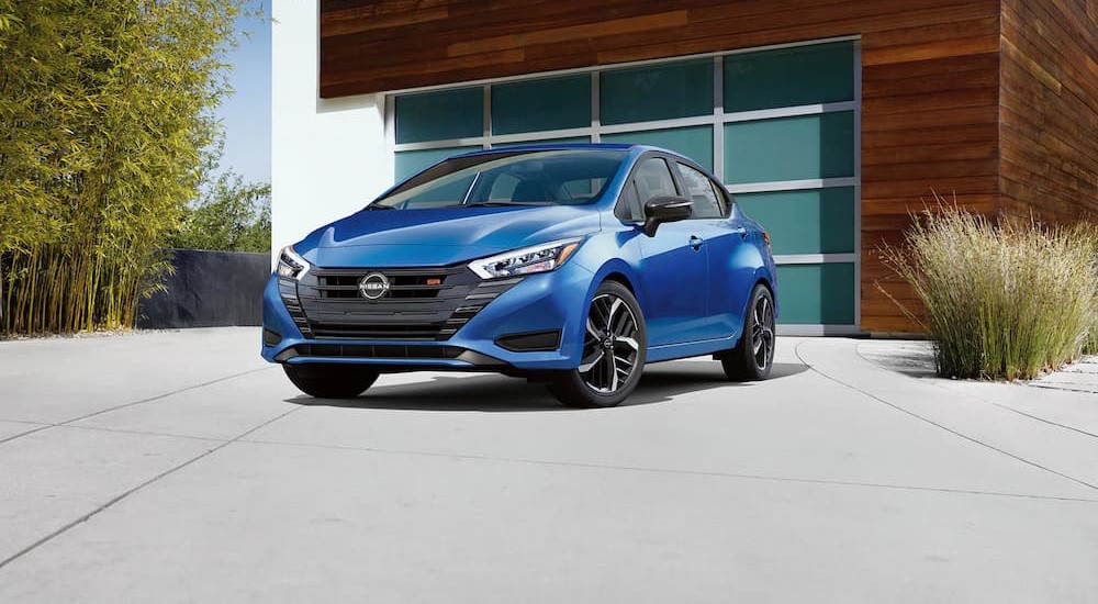 A blue 2023 Nissan Versa SR in seen parked on a driveway.