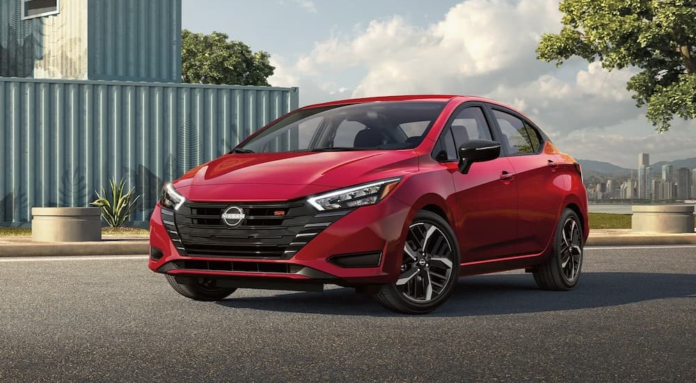 A red 2023 Nissan Versa SR is shown parked on a driveway.