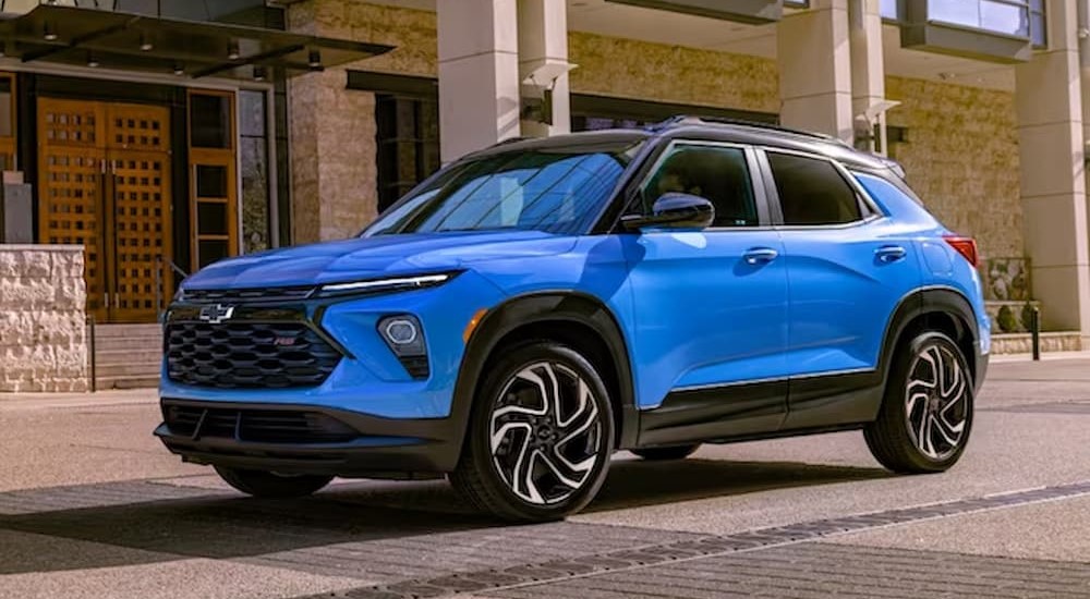 A blue 2024 Chevy Trailblazer RS is shown parked near a building.