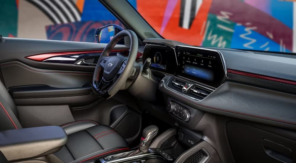 The red and black interior and dash of a 2024 Chevy Trailblazer is shown.