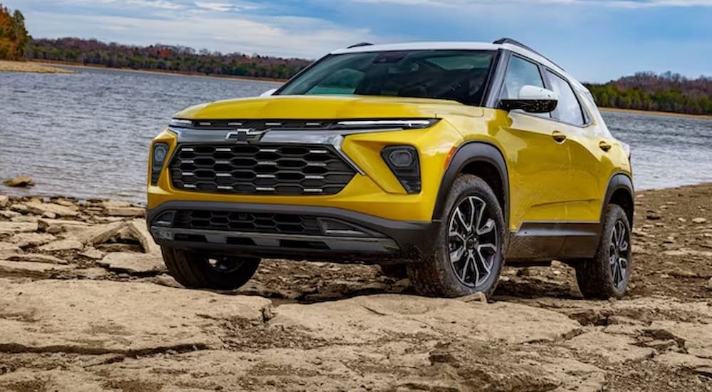 A yellow 2024 Chevy Trailblazer is shown parked off road.