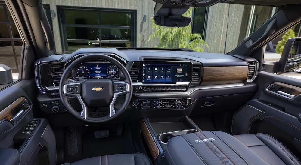 The black interior of A 2024 Chevy Silverado 2500HD is shown from the drivers seat.