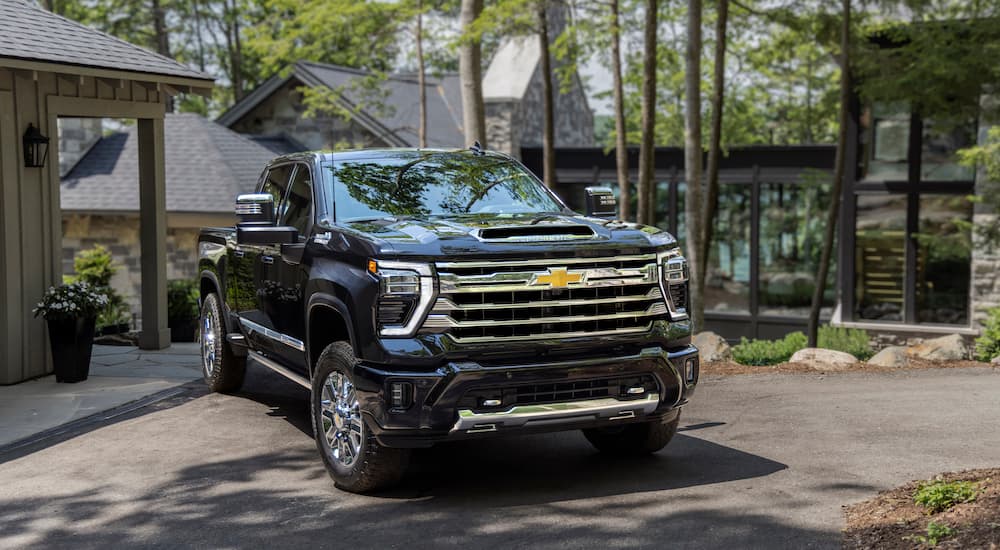 A black 2024 Chevy Silverado 2500 HD is shown from the front at an angle.