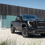 A black 2024 GMC Sierra 2500 HD Denali Ultimate is shown from the front at an angle.