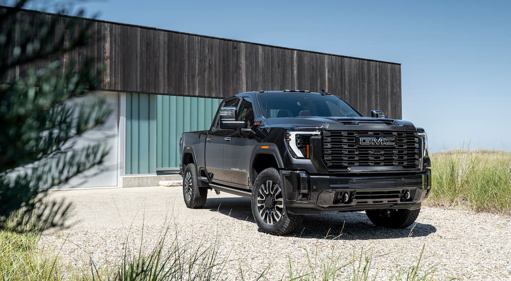 A black 2024 GMC Sierra 2500 HD Denali Ultimate is shown from the front at an angle.