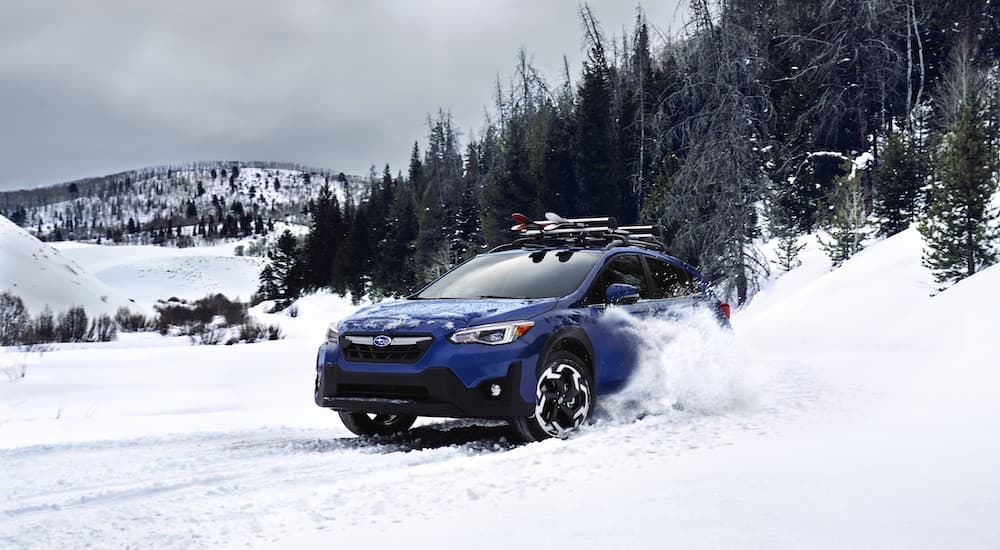A blue 2023 Subaru Crosstrek Limited is shown from the front at an angle.