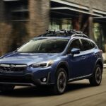 A blue 2023 Subaru Crosstrek is shown from the front at an angle.