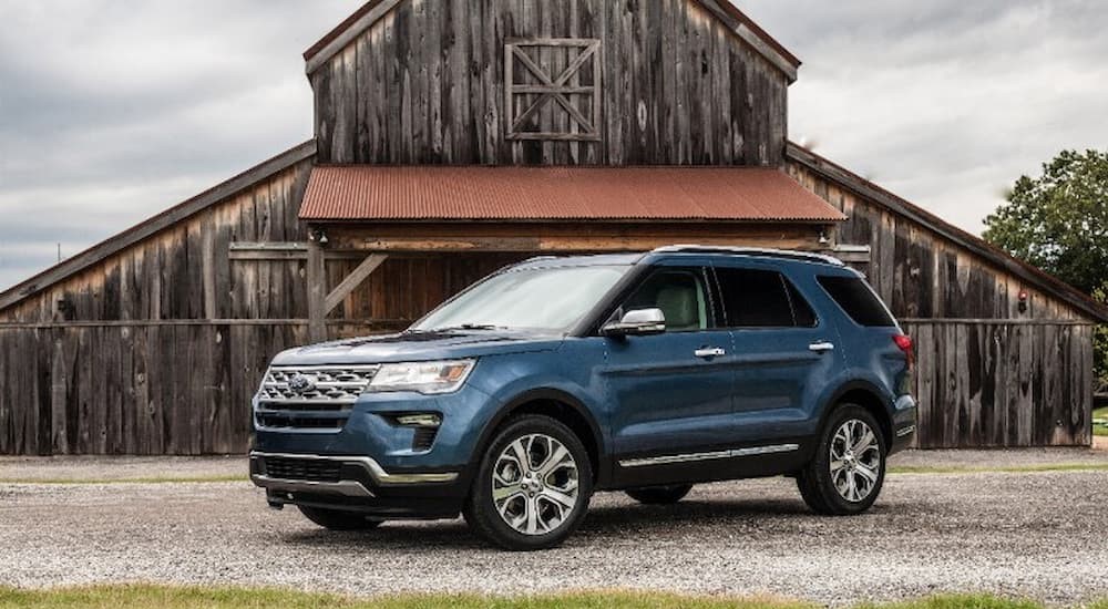 A 2019 Ford Explorer is shown parked in front of a barn.