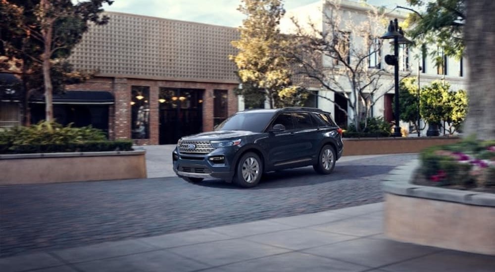 A blue 2023 Ford Explorer for sale is shown parked on a street.