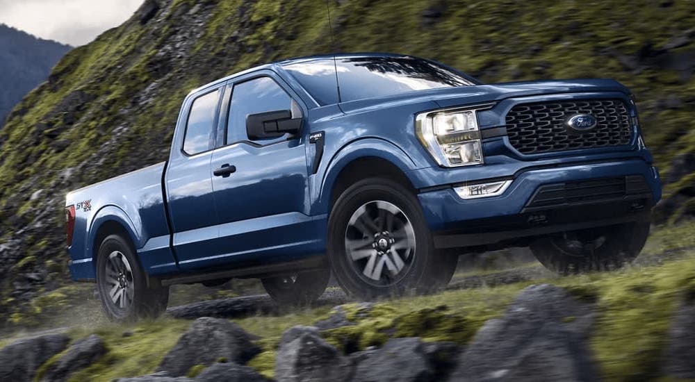 A blue 2023 Ford F-150 XLT is shown from the front at an angle.