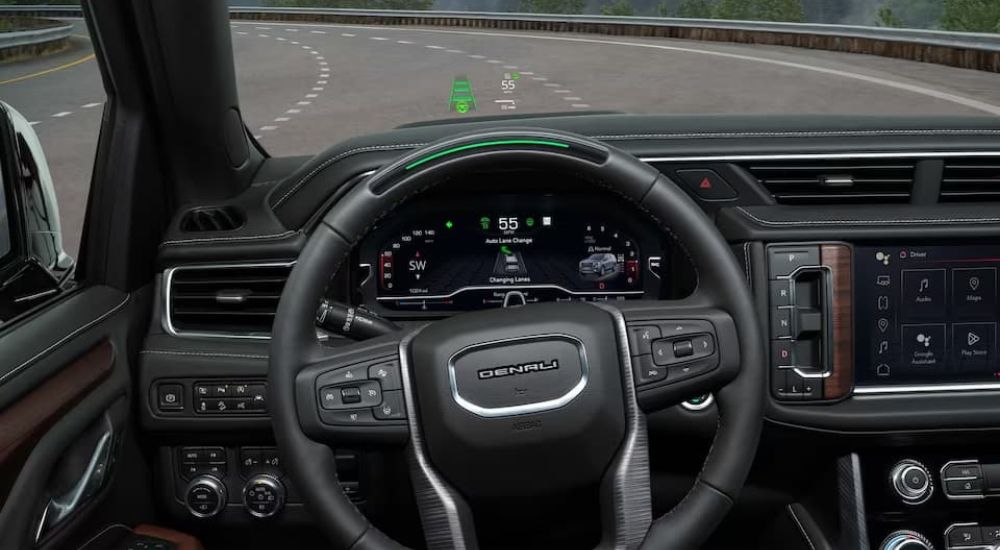 A close-up of the wheel of a GMC Sierra 1500 Denali is shown with the Super Cruise system in use.