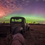 An old truck is seen parked years after leaving a GMC dealership.