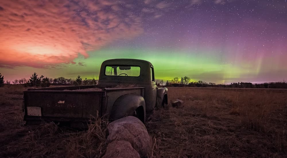 An old truck is seen parked years after leaving a GMC dealership.