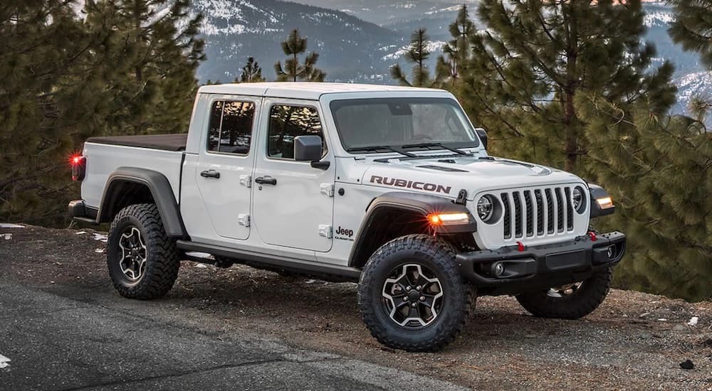 A white 2023 Jeep Gladiator Rubicon is shown from the front at an angle.