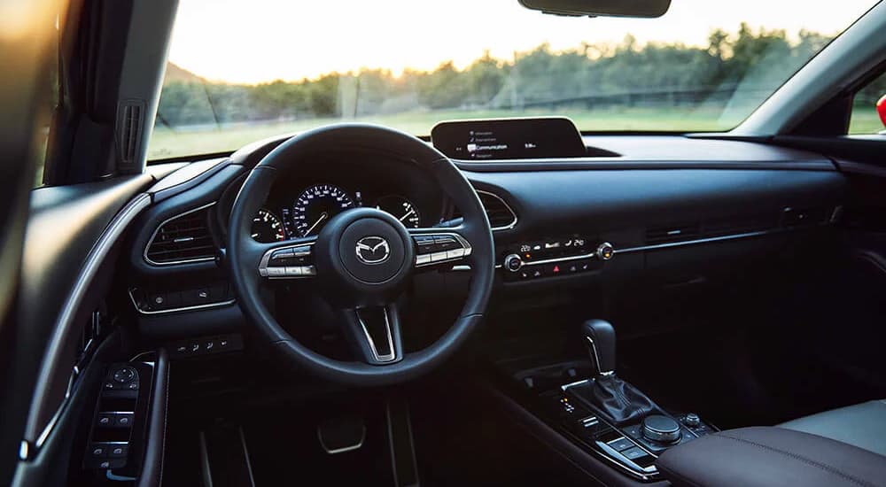 The luxurious interior of a 2023 Mazda CX-30 for sale is shown with leather seats.