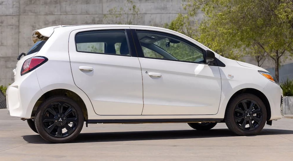 A white 2023 Mitsubishi Mirage is shown parked.