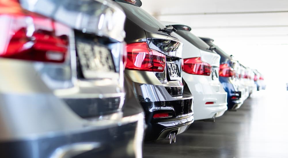 A row of new cars is shown at a dealership that provides lease buyouts.