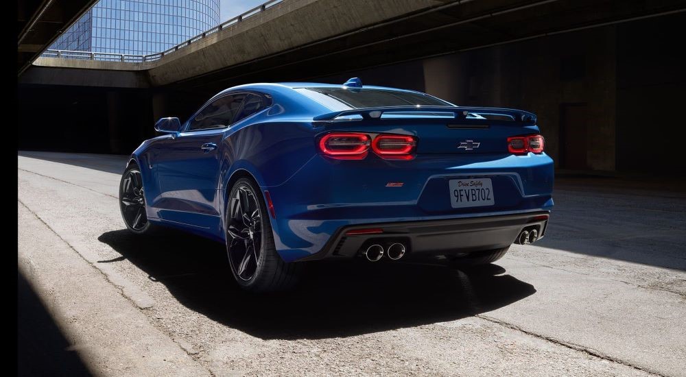 A blue 2023 Chevy Camaro is shown from the rear.