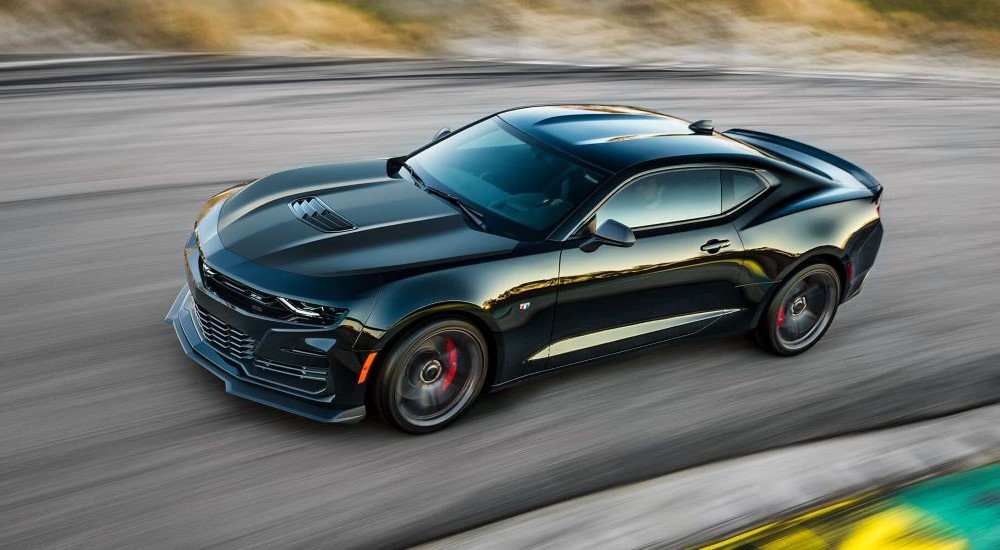 A black 2023 Chevy Camaro ZL1 is shown driving on a road.