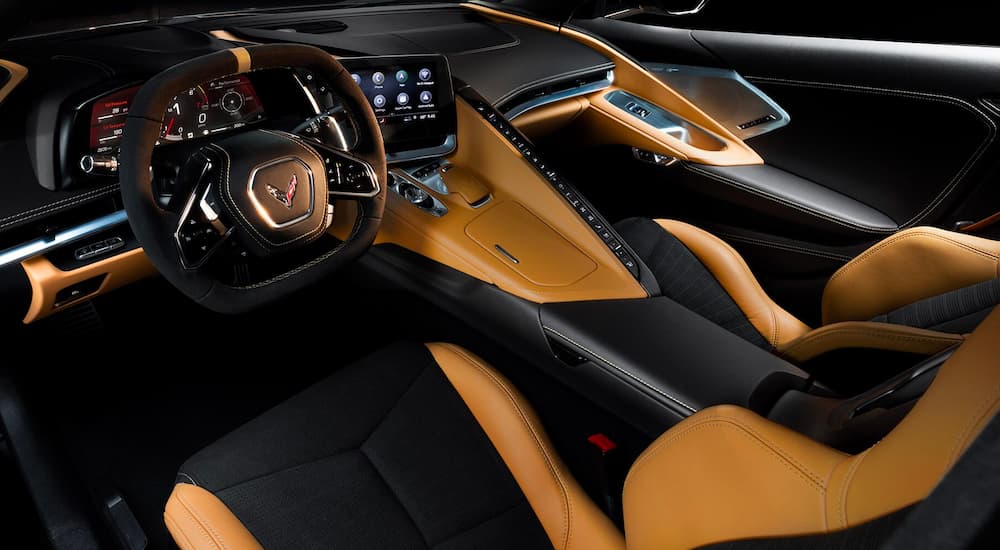 The Natural/Black colored front interior of the 2023 Corvette 3LT coupe is shown.