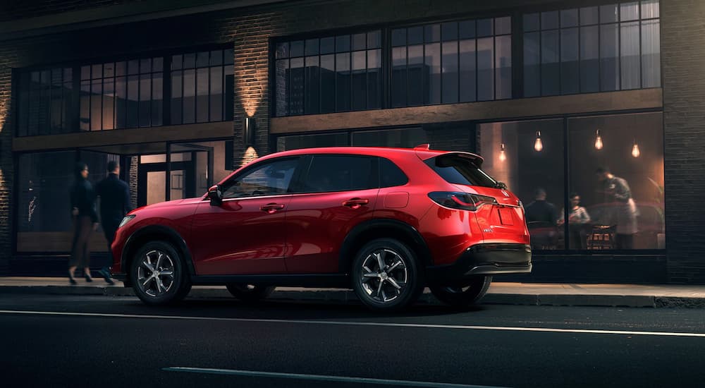 A red 2023 Honda HR-V is shown parked near a restaurant.