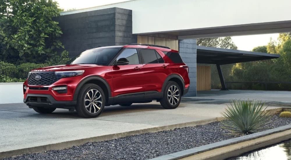 A red 2023 Ford Explorer is shown parked on a driveway.