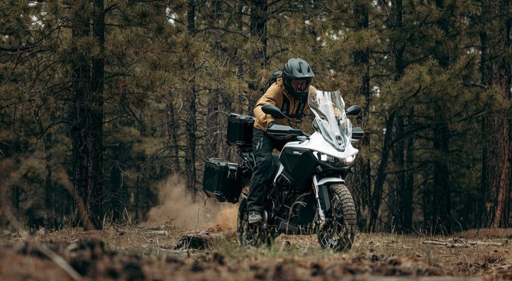 A black and white 2023 Zero DSRX is shown being ridden off-road.