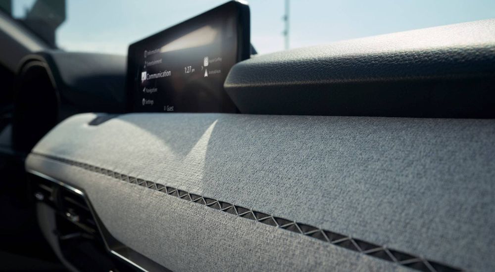 A close-up of the Kakenui stitching is shown on the dashboard of a 2024 Mazda CX-90.