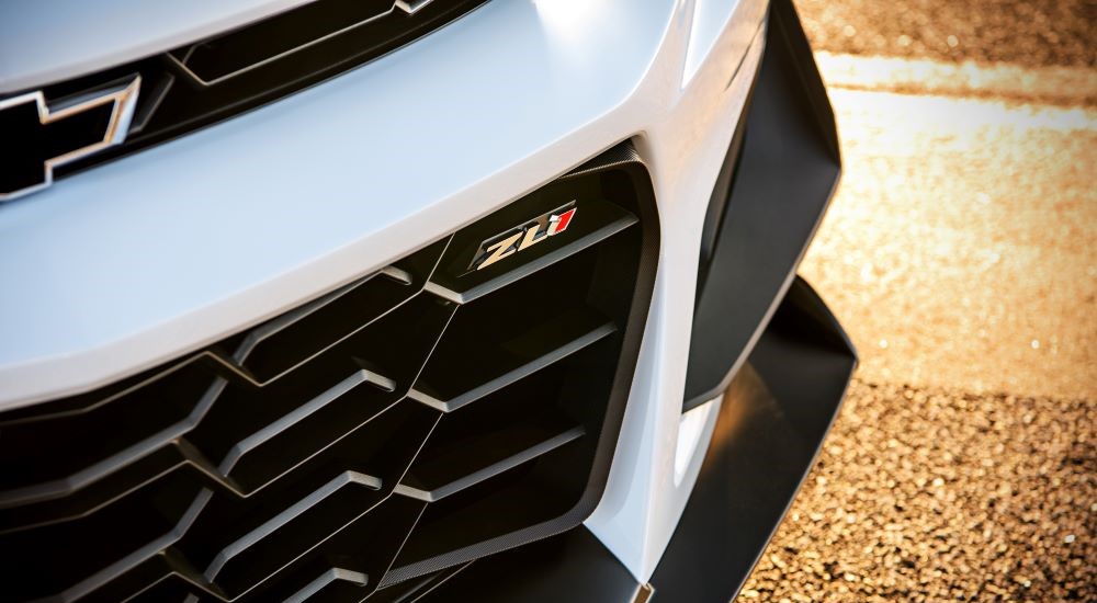 A close up shows the ZL1 badge on a white 2023 Chevy Camaro ZL1 1LE.