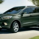 A green 2019 Ford Escape for sale is shown driving on a road.
