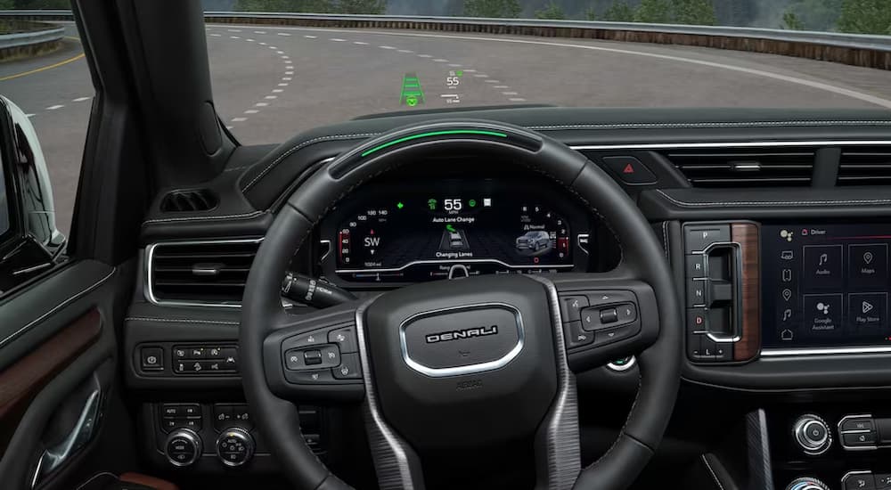 The driver's view of a 2023 GMC Yukon Denali is shown using Super Cruise.