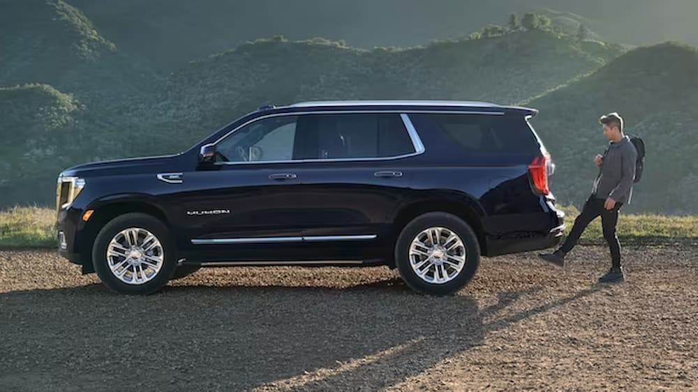 A blue 2023 GMC Yukon Denali Ultimate is shown parked off-road after visiting a GMC dealer in Mankato.