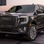 A black 2023 GMC Yukon Denali Ultimate is shown parked on a driveway.