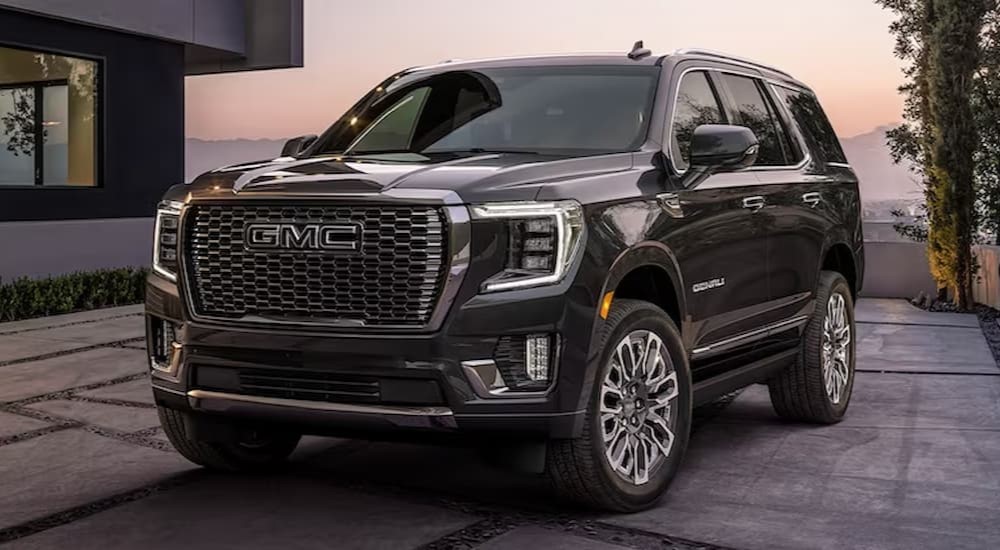 A black 2023 GMC Yukon Denali Ultimate is shown parked on a driveway.