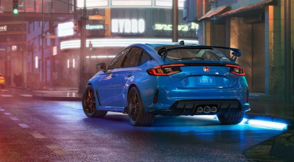 A blue 2023 Honda Civic Type-R is shown leaving a Honda dealer.