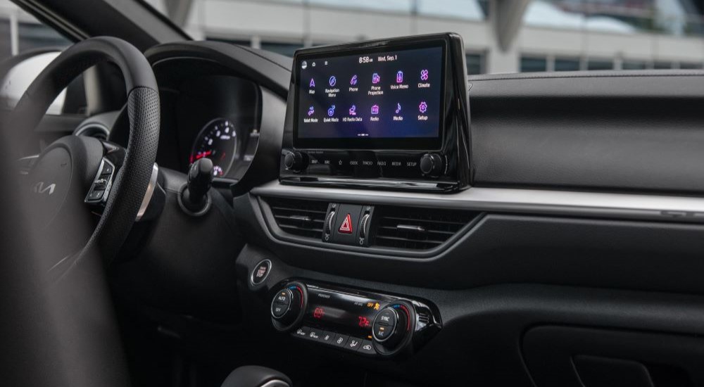 The interior and dash of a 2023 Kia Forte is shown.