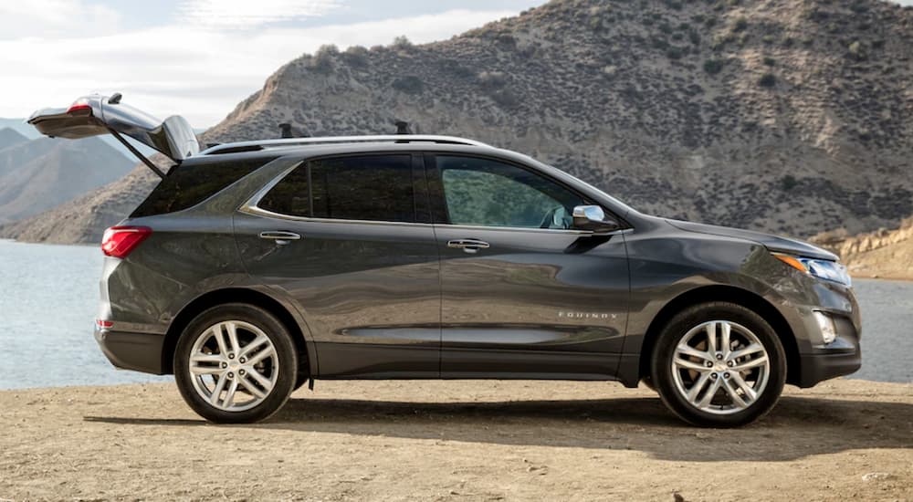 A dark gray 2020 Chevy Equinox is shown parked near a lake.